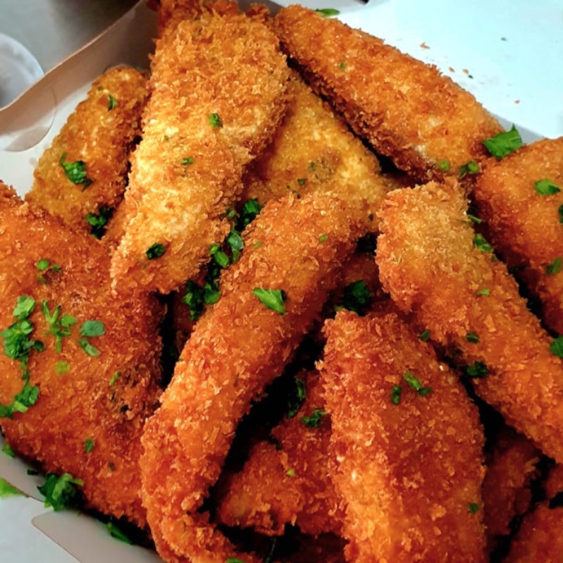 Porção de tiras de  tilápia à milanesa com gergelim 