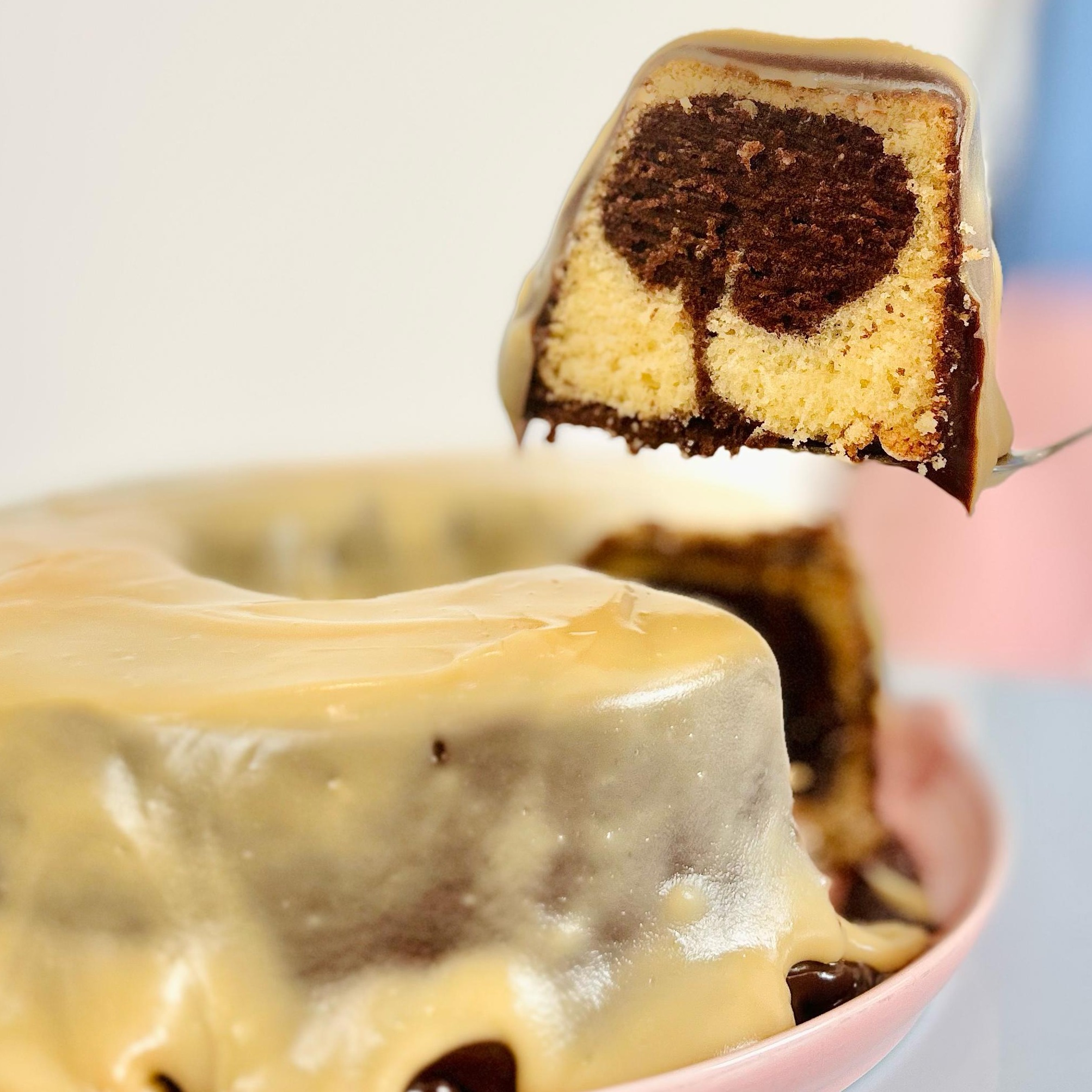 Fatia de bolo mesclado com calda de chocolate  e brigadeiro branco